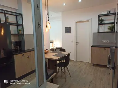 a kitchen with a table and a dining room at Argous - Athens City Center Apartment in Athens