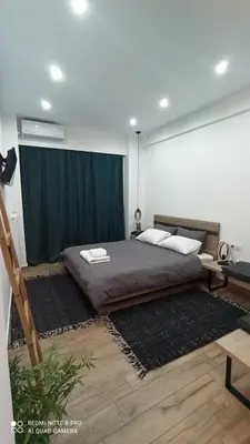 a bedroom with a large bed and a desk at Argous - Athens City Center Apartment in Athens