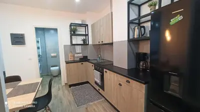 a kitchen with a black refrigerator and a table at Argous - Athens City Center Apartment in Athens
