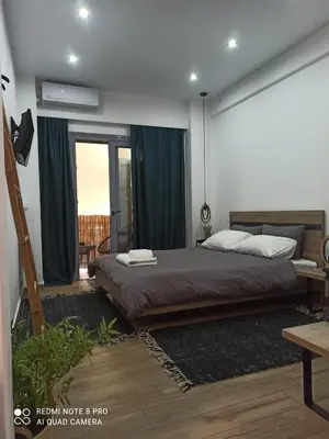 a bedroom with a bed in a room with a window at Argous - Athens City Center Apartment in Athens