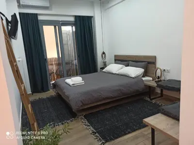 a bedroom with a bed with two pillows on it at Argous - Athens City Center Apartment in Athens