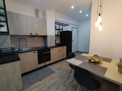 a kitchen with a wooden table and a dining room at Argous - Athens City Center Apartment in Athens