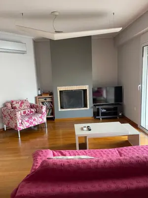 a living room with a couch and a table at ΔΙΑΜΕΡΙΣΜΑ ΜΕ ΘΕΑ in Athens