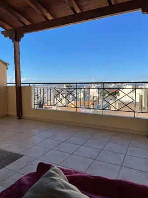 a room with a balcony with a view of a building at ΔΙΑΜΕΡΙΣΜΑ ΜΕ ΘΕΑ in Athens