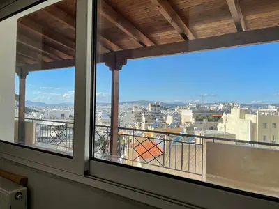a view of a city from a window at ΔΙΑΜΕΡΙΣΜΑ ΜΕ ΘΕΑ in Athens