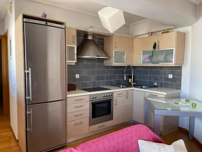 a kitchen with a large stainless steel refrigerator at ΔΙΑΜΕΡΙΣΜΑ ΜΕ ΘΕΑ in Athens