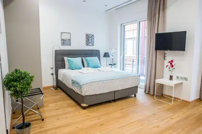 a bedroom with a bed and a television in it at A25 Pristine & Sunny flat with balcony at downtown Athens in Athens
