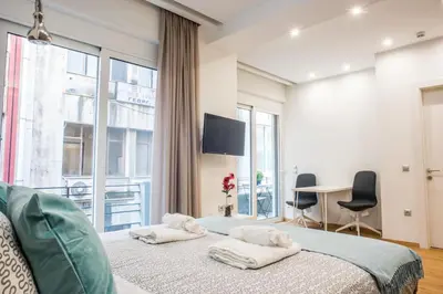 a bedroom with a bed with two towels on it at A25 Pristine & Sunny flat with balcony at downtown Athens in Athens