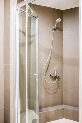 a shower with a glass door in a bathroom at A25 Pristine & Sunny flat with balcony at downtown Athens in Athens