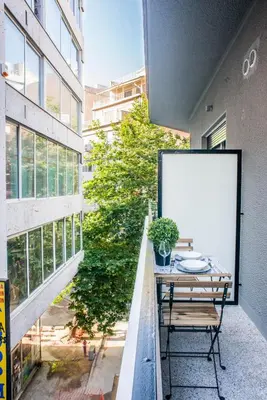 a table on the balcony of a building with a whiteboard at A25 Pristine & Sunny flat with balcony at downtown Athens in Athens