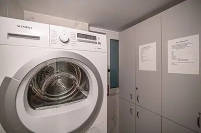 a white washing machine in a room with cabinets at A26 Premium flat near Monastiraki square in Athens in Athens