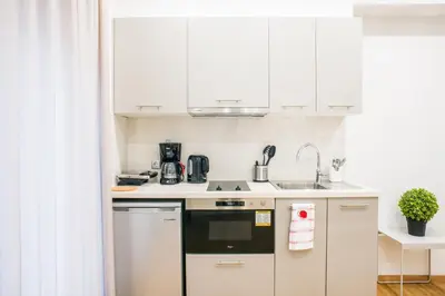 a small kitchen with white cabinets and a sink at A26 Premium flat near Monastiraki square in Athens in Athens