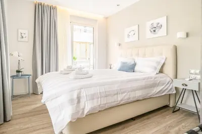a white bedroom with a large bed with white sheets at A15 Premium appartment up to 4ppl next to Parthenon! in Athens