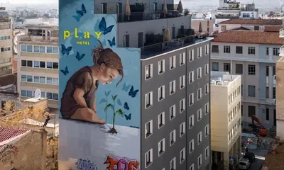 a building with a mural of a girl and butterflies at Play Theatrou Athens a member of Brown Hotels in Athens
