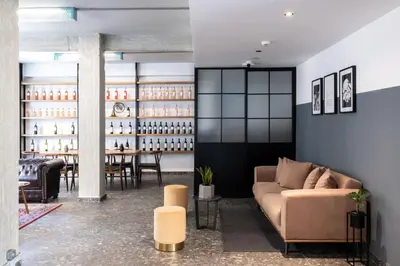 a living room with a couch and a table at Play Theatrou Athens a member of Brown Hotels in Athens