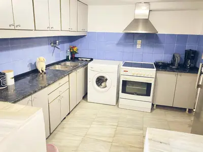 a kitchen with a washing machine and a washer at Thisio Loft in Athens