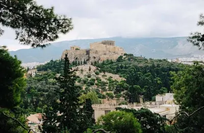 a castle on top of a hill with trees at Thisio Loft in Athens