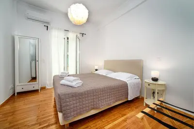 a bedroom with a bed with towels on it at Acropolis area family friendly 2bdr apartment in Athens