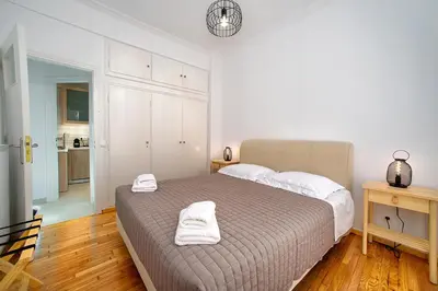 a bedroom with a bed with two towels on it at Acropolis area family friendly 2bdr apartment in Athens