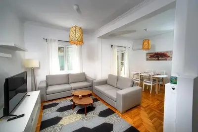 a living room with two couches and a table at Acropolis area family friendly 2bdr apartment in Athens