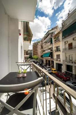 a balcony with a table and a view of a city at Acropolis area family friendly 2bdr apartment in Athens