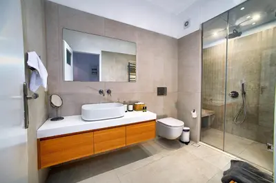 a bathroom with a sink and a toilet and a shower at Acropolis area family friendly 2bdr apartment in Athens