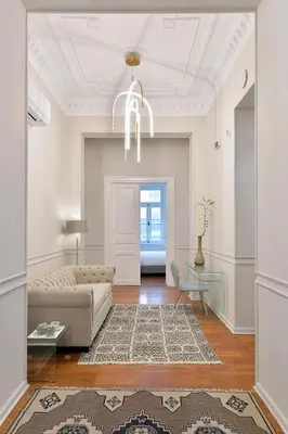 a living room with a couch and a chandelier at 1900 ATHENIAN HOUSE in Athens