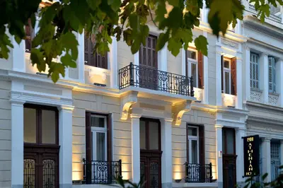 a white building with windows and balconies on it at 1900 ATHENIAN HOUSE in Athens