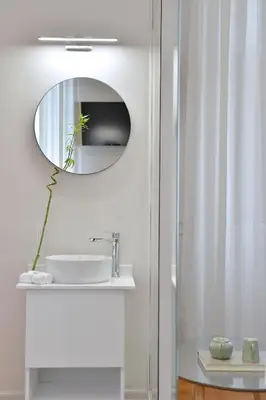 a bathroom with a sink and a mirror at 1900 ATHENIAN HOUSE in Athens
