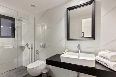 a bathroom with a sink and a toilet and a mirror at Classic Hotel by Athens Prime Hotels in Athens