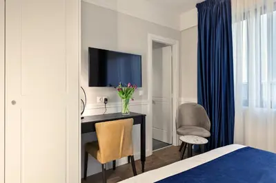 a bedroom with a desk with a television and a chair at Classic Hotel by Athens Prime Hotels in Athens