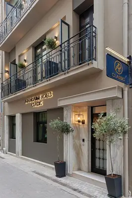 a building with two potted plants in front of it at Classic Hotel by Athens Prime Hotels in Athens