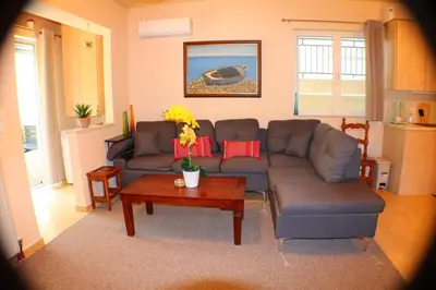 a living room with a couch and a table at Filoxenia Apartment in Athens