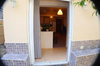 a hallway of a house with a mirror and a kitchen at Filoxenia Apartment in Athens