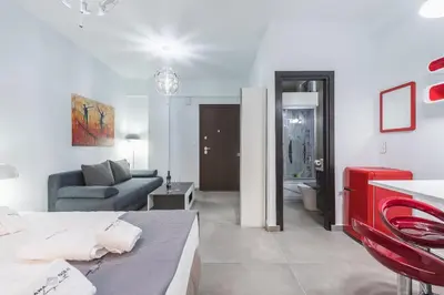 a living room with a couch and a table at Iguana Gold Luxury Suites 1min from Ermou str in Athens