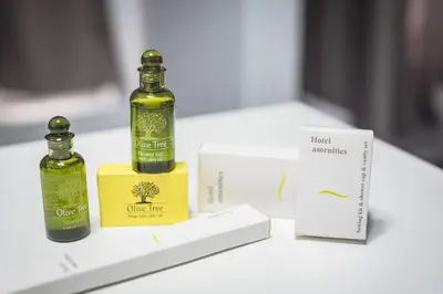 two bottles of olive oil sitting on a table at Iguana Gold Luxury Suites 1min from Ermou str in Athens