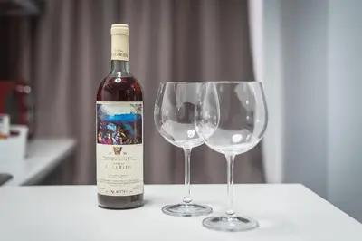 a bottle of wine sitting next to two wine glasses at Iguana Gold Luxury Suites 1min from Ermou str in Athens