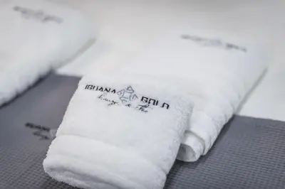 a white towel sitting on top of a table at Iguana Gold Luxury Suites 1min from Ermou str in Athens