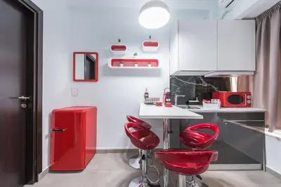a kitchen with red stools and a red refrigerator at Iguana Gold Luxury Suites 1min from Ermou str in Athens