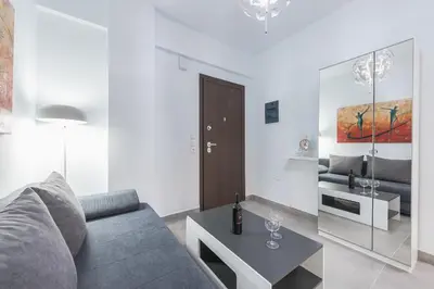 a living room with a couch and a table at Iguana Gold Luxury Suites 1min from Ermou str in Athens