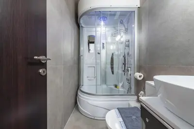 a bathroom with a shower and a toilet and a sink at Iguana Gold Luxury Suites 1min from Ermou str in Athens