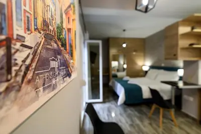 a hotel room with a bed and a painting on the wall at Athens Chic House in Athens