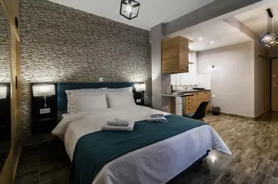 a bedroom with a large bed and a brick wall at Athens Chic House in Athens