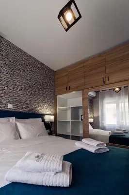 a bedroom with a large bed with two towels on it at Athens Chic House in Athens