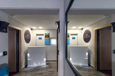 a hallway with doors and shelves in a building at Athens Chic House in Athens