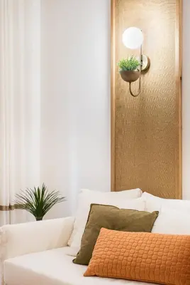 a white couch in a living room with a plant at Tree Olive Athens in Athens