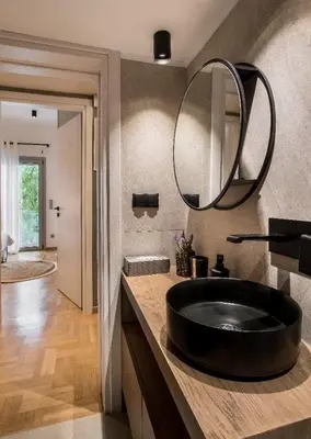 a bathroom with a black sink and a mirror at Tree Olive Athens in Athens