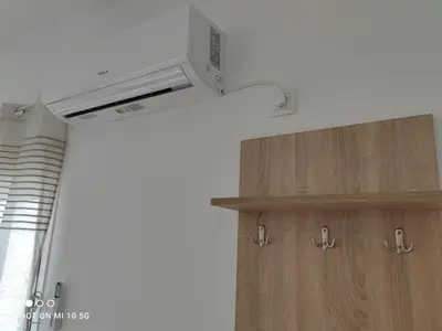 a kitchen with a ceiling fan and a wooden cabinet at Studio in the heart of Athens !!! in Athens