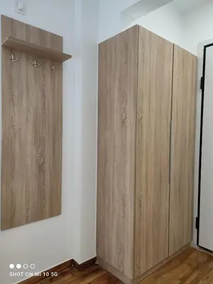 a room with two wooden cabinets on a wall at Studio in the heart of Athens !!! in Athens