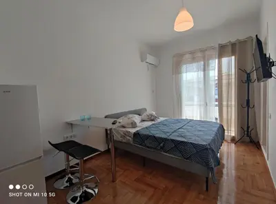 a bedroom with a bed and a desk and a chair at Studio in the heart of Athens !!! in Athens